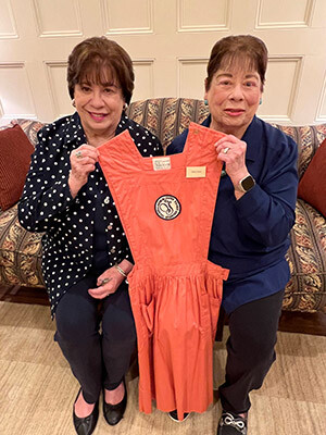 Carolyn-and-Connie-holding-volunteer-uniform